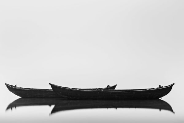 Black Boats - Classic Minimalistic Black and White Long Exposure Photograph in Limited Edition Pigment Prints on Canvas and Matte Papers by Minhajul Haque